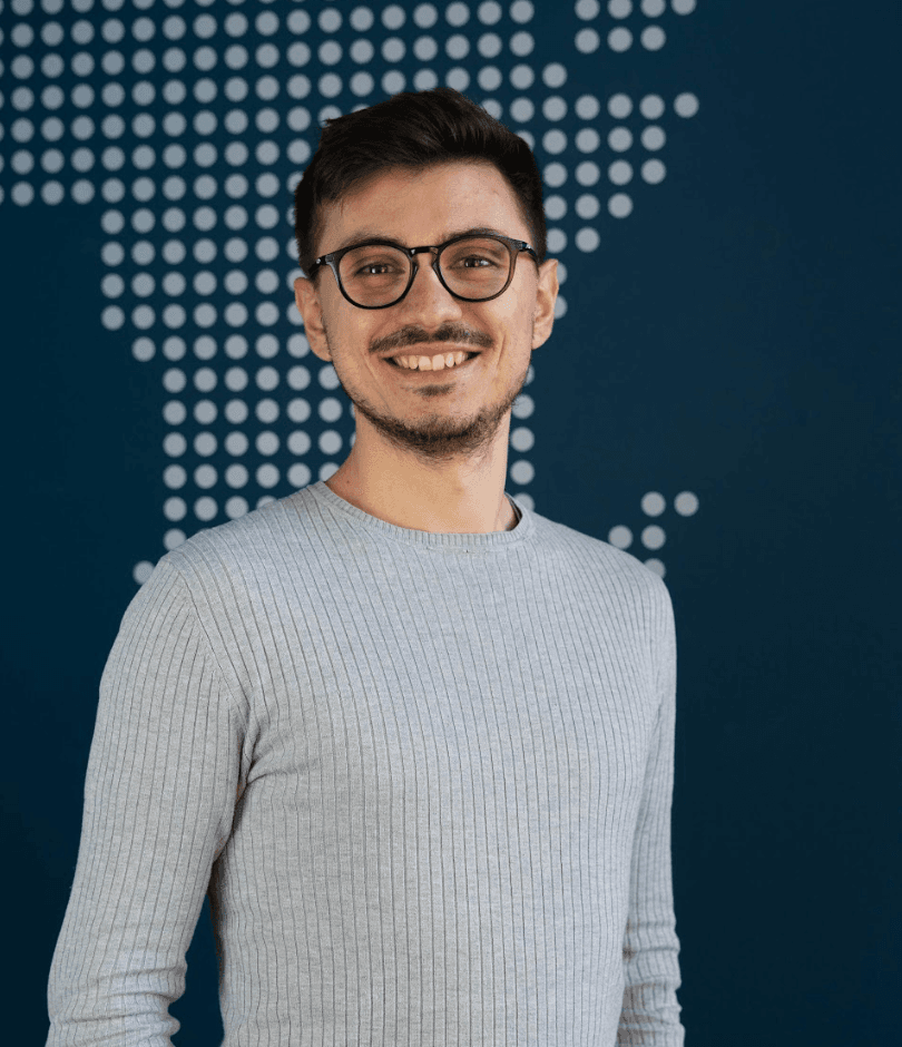 Man in light gray shirt on blue background