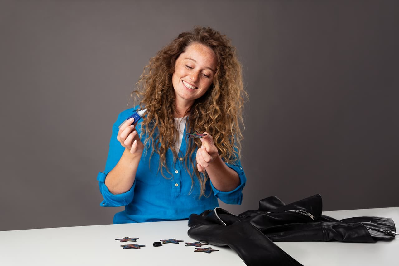 Woman in a blue shirt fixing a purse