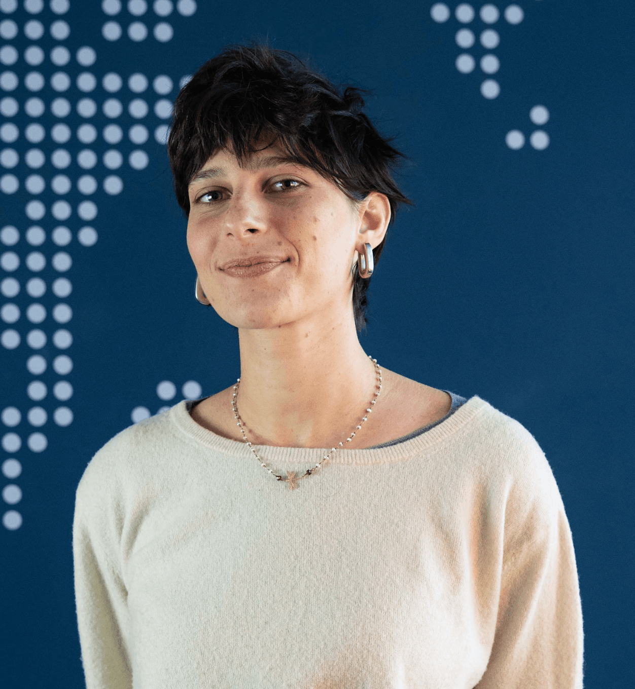 Woman in beige shirt on blue background